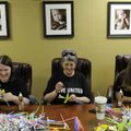 Erica Preston, left, LaJeana “Pete” Hester and Sarah Phipps of Simmons First Bank work to create flo...