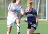 Fayetteville’s Anne Mitchell, right, and Bentonville’s Carlen Johnson go up for a header on April 15 during a match at Bentonville.