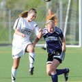 Fayetteville’s Anne Mitchell, right, and Bentonville’s Carlen Johnson go up for a header on April 15...