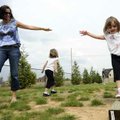  Lauren Nicholson, 3, of Rogers walks a balance beam Friday as her mother Tracy looks on at Pine Cre...