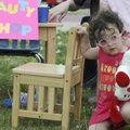  Roslyn Sullivan, 2, of Springdale, waits to get her hair done Friday at the “beauty shop” during th...