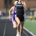 Bentonville senior Leah Whitlow heads toward the finish line and helps the Lady Tigers win the 3,200...