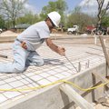 Renny Reyes with Professional Concrete Specialties bends a piece of iron Wednesday while preparing t...