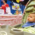 Alec Saxton, 6 months, passes by vendor booths Saturday during the Inaugural Northwest Health System...