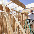 Keith Harviston with ARC Construction measures to install ceiling joists at a home under constructio...