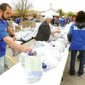 Matt Leonard with Life Connection Church in Rogers keeps bags of food stocked Saturday for area resi...