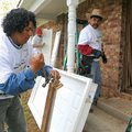 Rafael Pizano, left, pulls nails from a threshold Saturday as he and Justo Navarro, both with Handym...