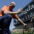 James Clark, technical services director for Springdale Water Utilities, demonstates Friday how to t...