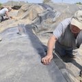 Willie Stilwell, right, and Denis Bookout, both with Roofing Systems of Springdale, seal a rubber po...
