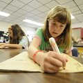Kimmie Parker, right, and Emily Redmon, both 10, work on grocery bag art projects Friday at West For...
