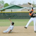 Gravette’s Chris Cowgur, right, is forced to make a high catch as Farmington’s Tony Morales steals s...