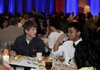 Springdale High School students Nicholas Hopkins, left, and Simon Luangsisombath eat dinner Monday during the Champions in Education banquet in Springdale at the Northwest Arkansas Convention Center. The banquet honors teachers, schools and students with 4.0 grade point averages.
