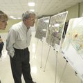 Dani and Richard Fried, who live near Lake Atalanta Park, look at plans Tuesday for renovating the p...