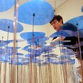Facilities crew member Matt Percival of Fayetteville cleans the tops of an installation titled "Blue...