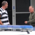 Benton County Judge Dave Bisbee, right, exits the Benton County Jail on Wednesday in Bentonville aft...