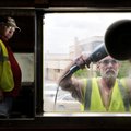 Phillip Mangham, right, polishes a window Wednesday on the Arkansas Missouri passenger train as Bud ...