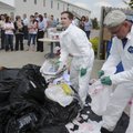 RETRIEVING RECYCLABLES - Tony Beardsley, right, and Digger Lauter, both with the Clorox Company’s sa...
