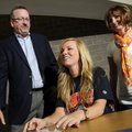  Rogers High senior Caroline Kelley, center, smiles to the applause of her friends and classmates as...