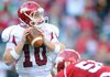 Quarterback Nick Petrino drops back to pass during the first half of the annual Red-White game Saturday at Razorback Stadium.