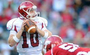 Quarterback Nick Petrino drops back to pass during the first half of the annual Red-White game Saturday at Razorback Stadium.