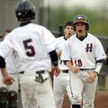Rogers Heritage’s Brandon Brzozkiewicz, right, celebrates after crossing the plate ahead of teammate...