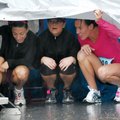 Jacki Doyle, right, Melissa Herrington, center, and Marcy Bagwell sit under a tarp Saturday as they ...
