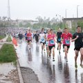 DRENCHED DASH - Runners make their way through the rain Saturday at the start the Race for The Cure ...