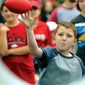 FAMILY FUN - Benjamin Armijo, 8, of Fort Smith takes aim Saturday for the bulls-eye while playing a ...