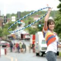 RAIN OR SHINE - Jessey Carter of Fayetteville smiles Saturday while demonstrating her Hypnohoops on ...