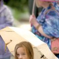 Elaina Gardner, 4, stands beneath an umbrella while enjoying the 28th annual Springfest Saturday, Ap...