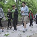 Area residents walk Sunday through Compton Gardens in Bentonville during the Aveda Walk for Water sp...