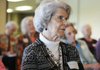 Mary Stewart of Bella Vista listens to candidates for Benton County judge and sheriff speak Monday during a forum hosted by the Bella Vista Republican Women in Bella Vista.