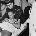In this Feb. 21, 1965 file photo, New York City Police Sgt. Alvin Aronoff grips hands of 22-year-old...