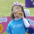    Collin Thompson, first grader from Shaw Elementary School demonstrates how to look through a magn...