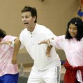 Former NFL player Bo Eason sets a theatrical kickoff block Tuesday with Alysia White (from left), 9,...