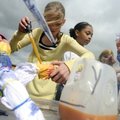 Fifth-graders Autumn Palmer, 11, left, and Kaylee Zamastil, 10, work to tie-dye T-shirts with their ...