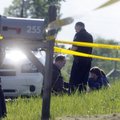 A woman believed to be Elaine Cox sits in the grass after a 6-year-old girl was shot in her home Tue...
