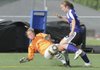 Bentonville goalkeeper Abby Risner comes out to challenge Fayetteville’s Casey O’Brien on April 15 at Bentonville.