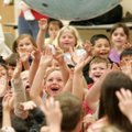 Sugar Creek Elementary School students reach Wednesday for a giant inflatable globe during a perform...