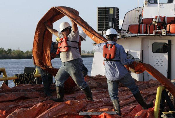 workers-load-a-boat-with-oil-booms-to-be-used-to-help-contain-leakage-from-an-underwater-well-thursday-near-venice-la