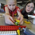 Shailyn Conner, left, and Niamh Martinez work on their plastic building block robot Wednesday at the...