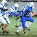 Woodland Junior High quarterback Austin Allen runs away from the Rogers High defense during the 
se...