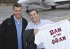  Dan Mullen, right, currently the offensive coordinator at Florida, holds up a T-shirt presented to to him by Mississippi State athletic director Greg Byrne, left, following their flight arriving at the Starkville Miss. airport on Wednesday