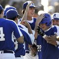  Rogers High’s Jake Rylee is congratulated by his teammates following his two-run home run during Th...