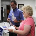 Gordon Fischer, left, and Debbie Fischer look over brochures Thursday of candidates running for elec...