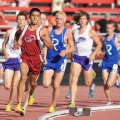  Springdale junior Gabe Gonzalez leads the field on his way to a second-place finish in the mile run...