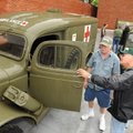  Jim Sanders, center of Baytown, Texas, shows his 1942 Dodge ambulance on Friday to Everett Avery of...