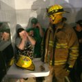 Brandy Covington, 28, talks with a firefighter as they and others take shelter Friday night in a bat...