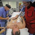 Dr. Michael Green, right, and registered nurse David Womack participate in an exercise with heart at...