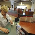 MAKING A DEPOSIT - Caroline Lennox of Fayetteville fills out a deposit slip Thursday at UARK Credit ...